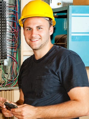 Electrician in hard hat smiling