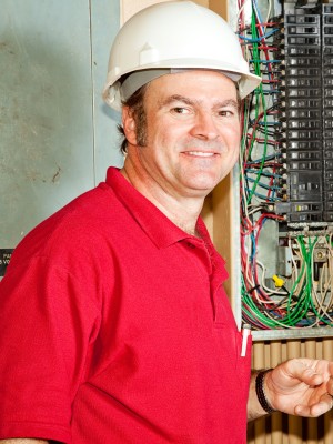 Electrician at fuse box
